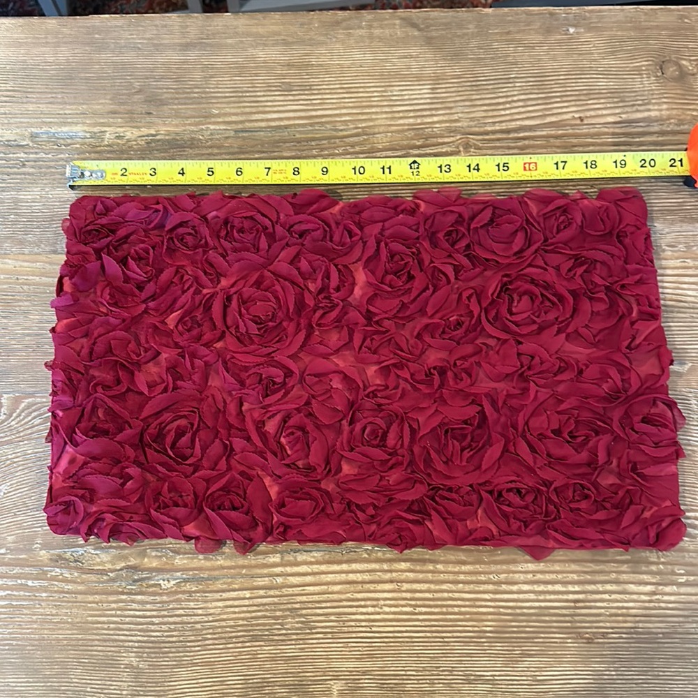 Red pillow case with embellishments of rose flowers zipper